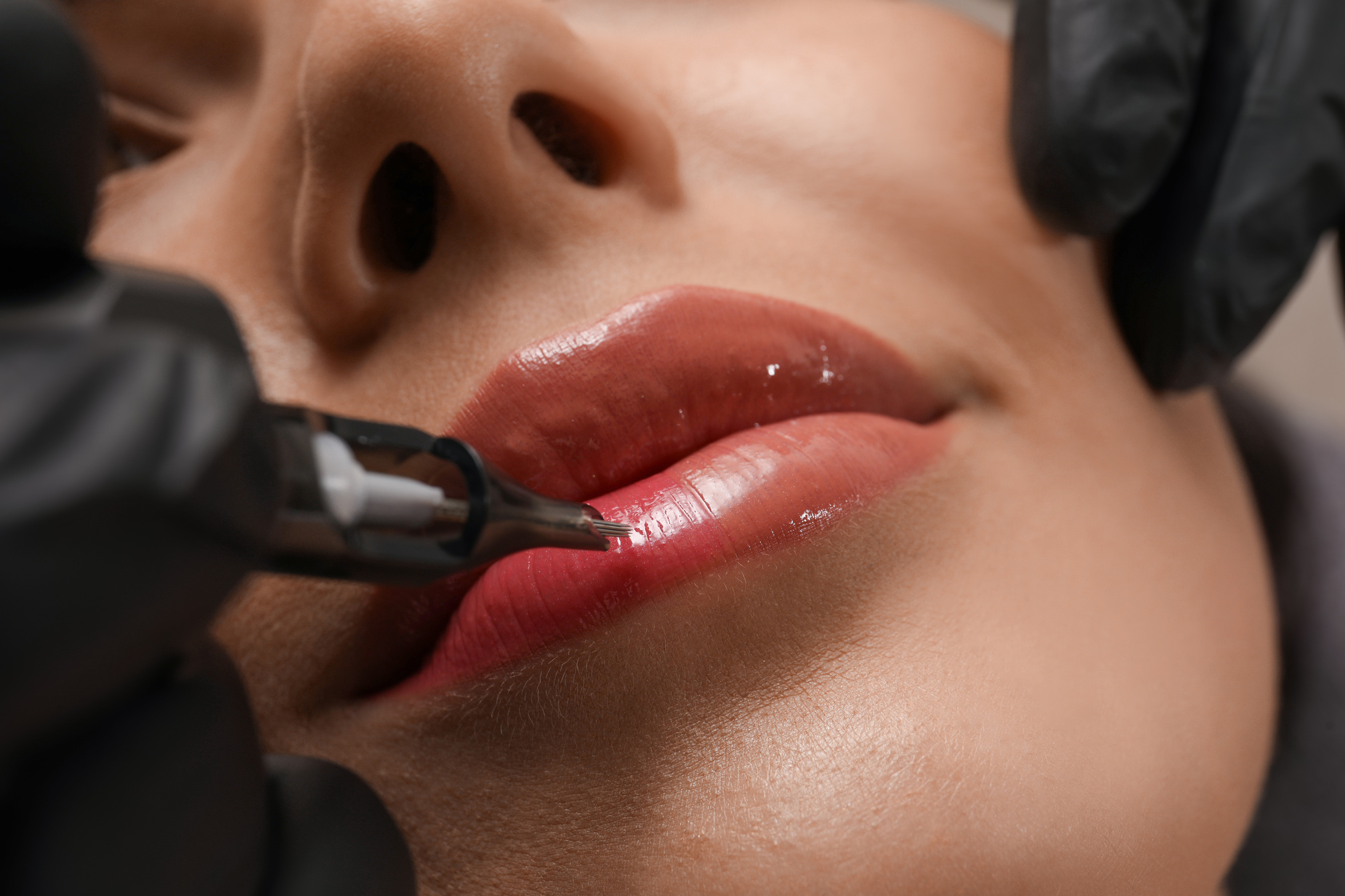 Young Woman Undergoing Procedure of Permanent Lip Makeup in Tatt