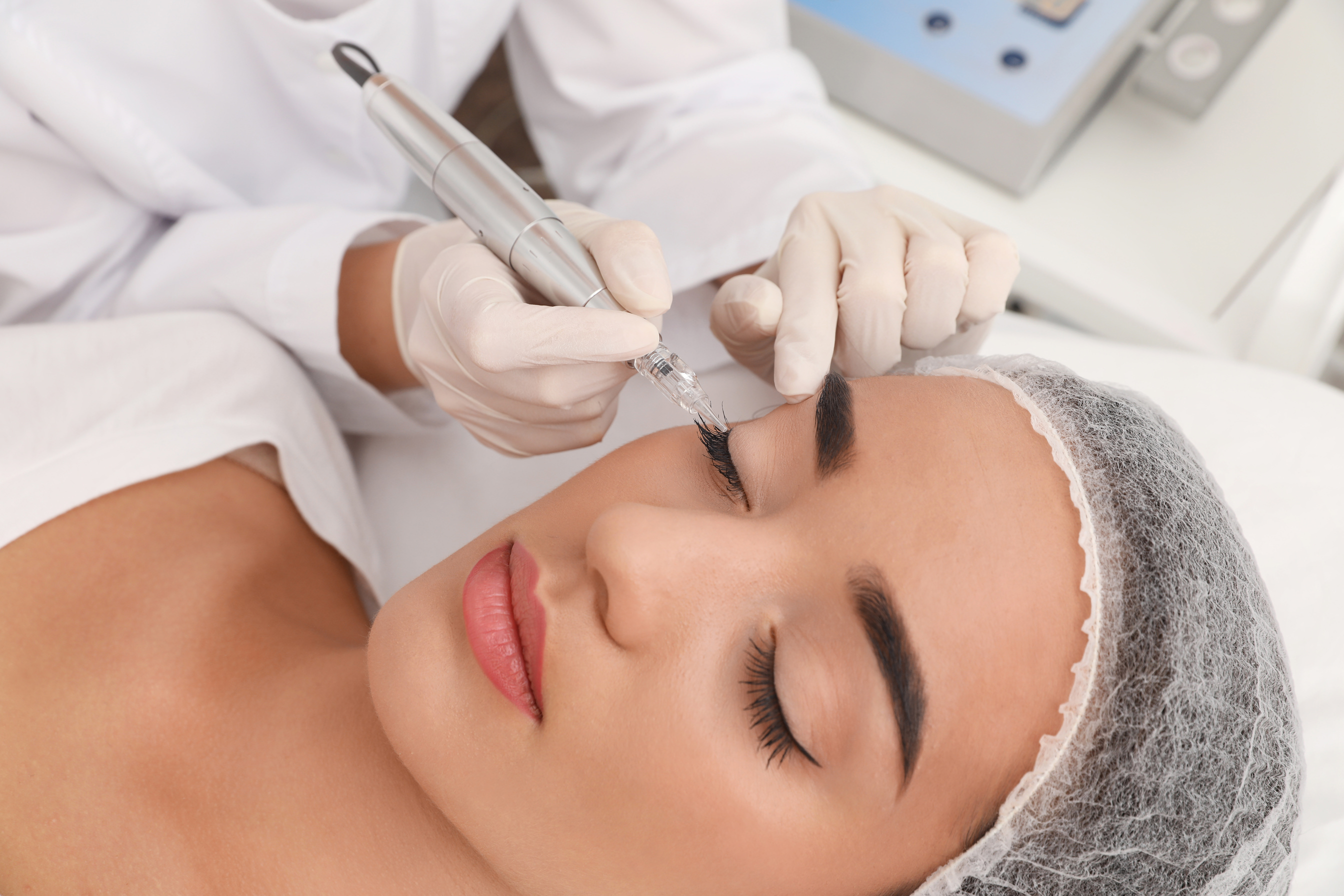 Young Woman Undergoing Procedure of Permanent Eye Makeup in Tattoo Salon, Closeup